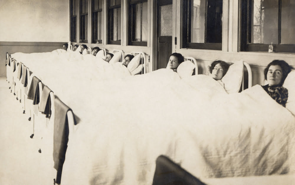 black & white photo of women in hospital beds