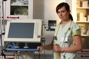 Portrait female nurse in ICU in with ventilator