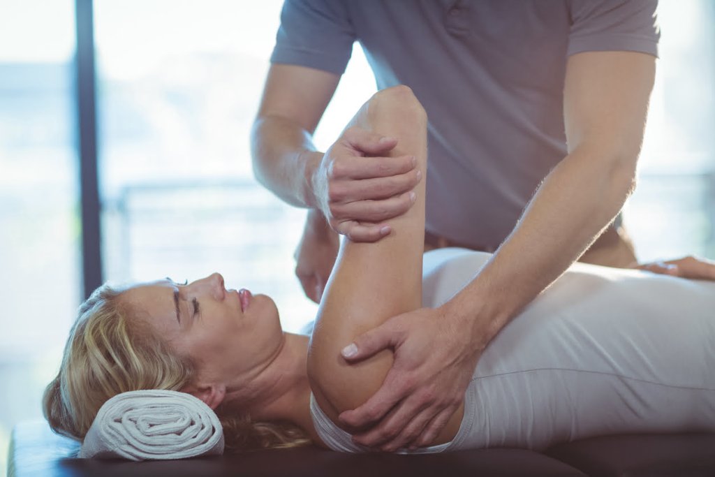 Woman having physiotherapy for frozen shoulder