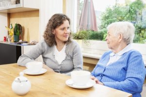 caregiver listening to senior woman
