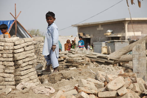 A child stands amongst the remains of buildings destroyed by the floods in Sindh province, Pakistan.