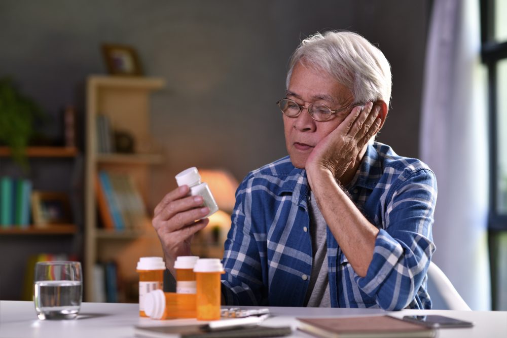 Asian senior man with his medicine bottles